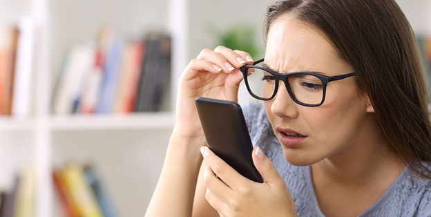 Image of lady squinting at phone.